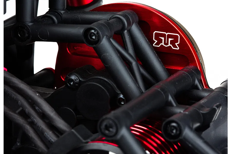 Close-up of a red anodized aluminium motor mount plate installed on an ARRMA RC vehicle chassis, featuring the ARRMA logo.