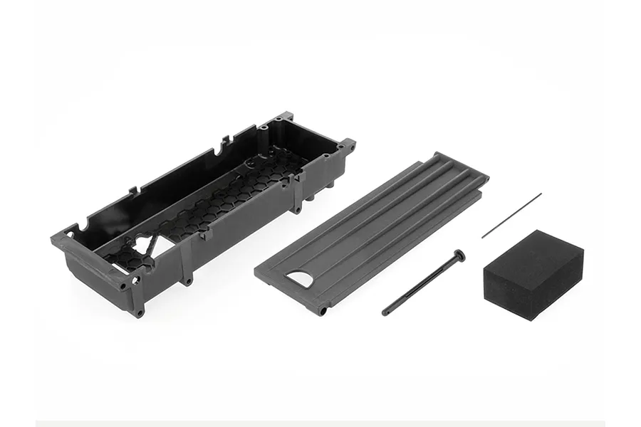 ARRMA long chassis tray set including a black plastic battery tray, lid, body clip, and foam spacer on a white background.