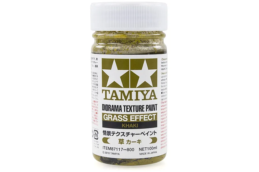 A 100ml jar of Tamiya Khaki Grass Effect Diorama Texture Paint, featuring a white screw-top lid and a label with the Tamiya logo.