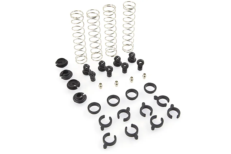 A collection of HSP RC4 shock absorber spare parts including four metal springs, plastic shock ends, spacers, and small metal pivot balls on a white background.