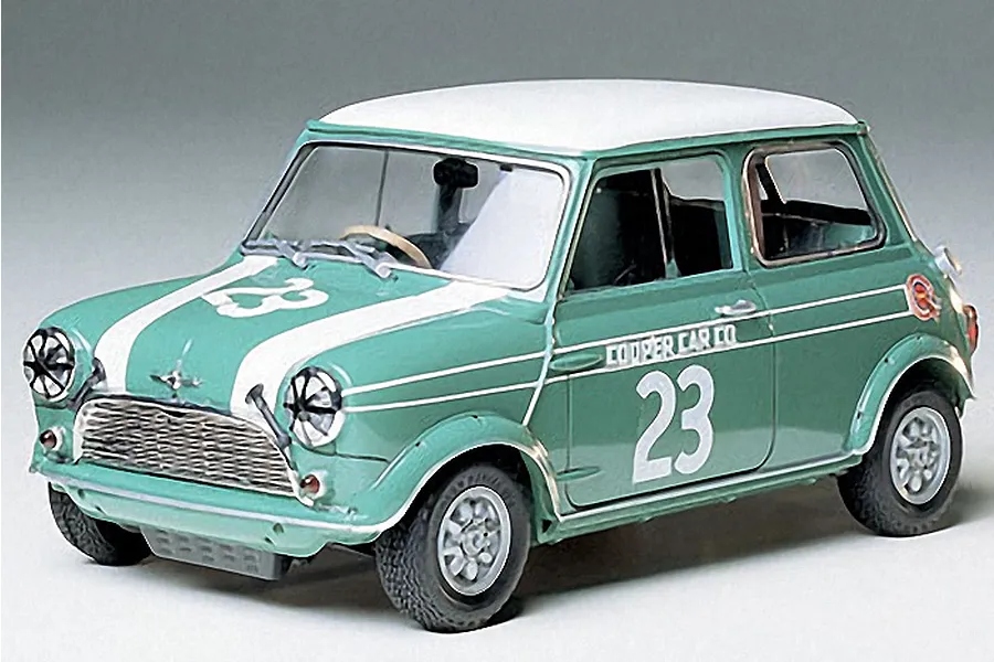 A 1/24 scale Tamiya Morris Mini Cooper model car, painted green with a white roof and racing number 23 on the hood and doors.