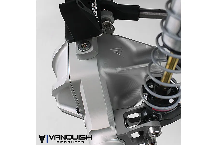 Close-up of a silver aluminium Vanquish differential housing installed on an RC vehicle chassis with suspension components.
