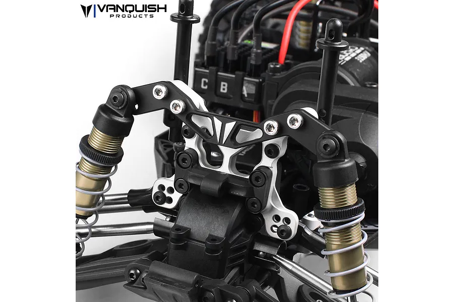 Vanquish Products silver aluminium front shock mount adjuster installed on an RC vehicle chassis.