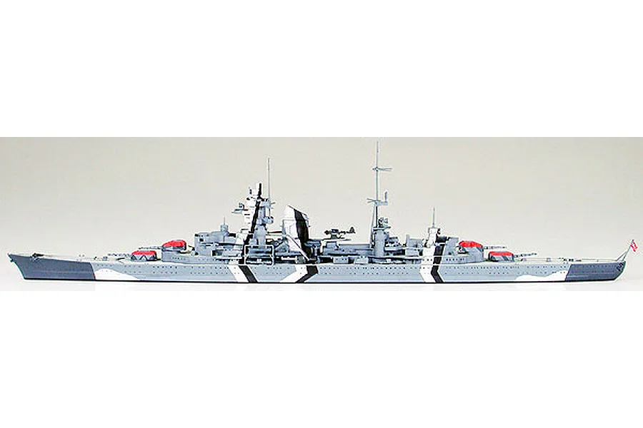 A side-profile view of a completed 1/700 scale Tamiya plastic model of the German heavy cruiser Prinz Eugen with a grey and white camouflage pattern.