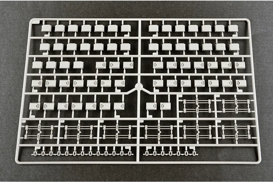 A grey plastic model kit sprue containing numerous small rectangular track pad components for a 1/16 scale tank model.