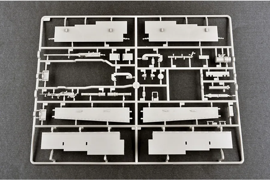 A grey plastic sprue containing various model tank parts, including side panels and machine gun components, for a 1/16 scale model kit.
