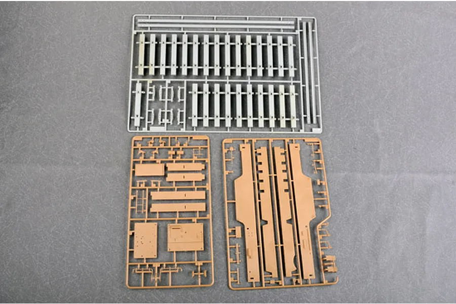 Three plastic model kit sprues for a 1/35 scale military vehicle, including railway track sections and structural parts.