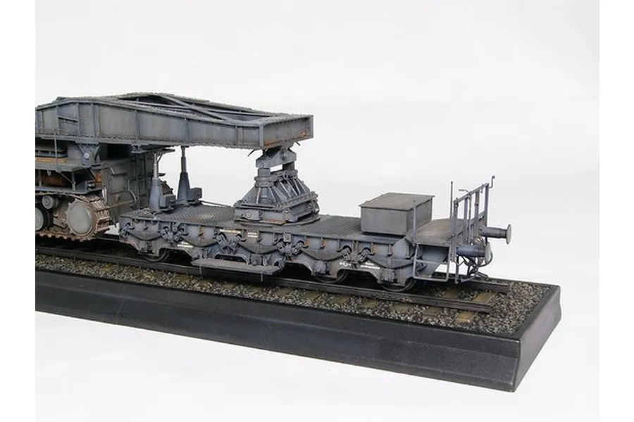 A detailed scale model of a German Morser Karl railway transport carrier on a display base.