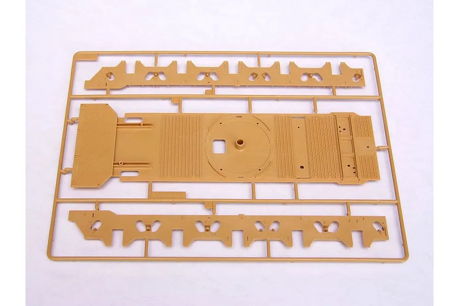 A tan plastic model kit sprue containing a large flat chassis piece and two long side frame components for a 1/35 scale military vehicle model.