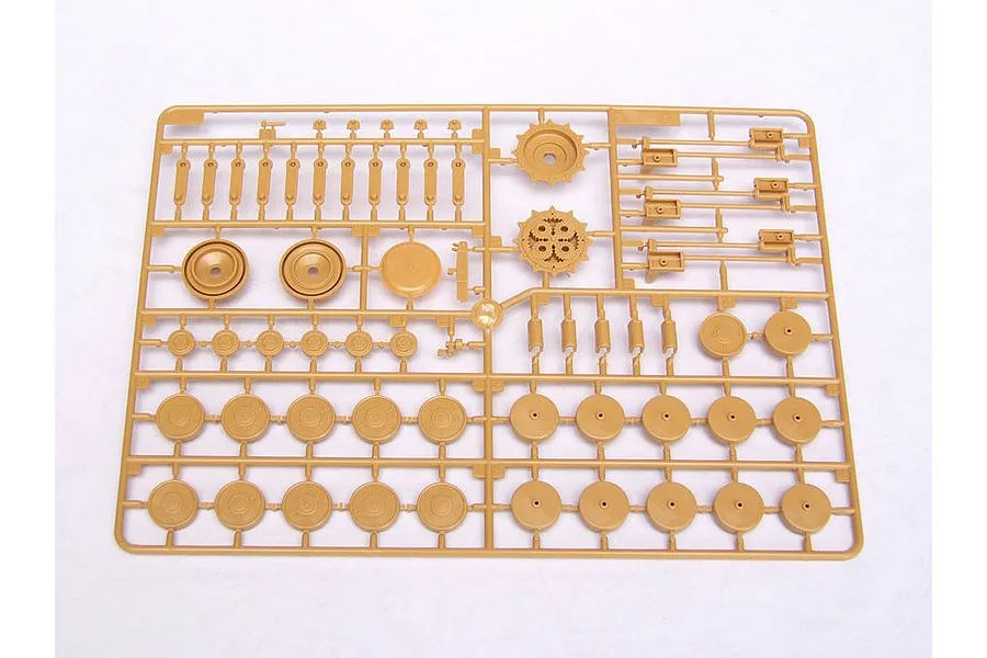 A tan plastic model kit sprue containing various circular road wheels, sprockets, and suspension components for a military vehicle model.