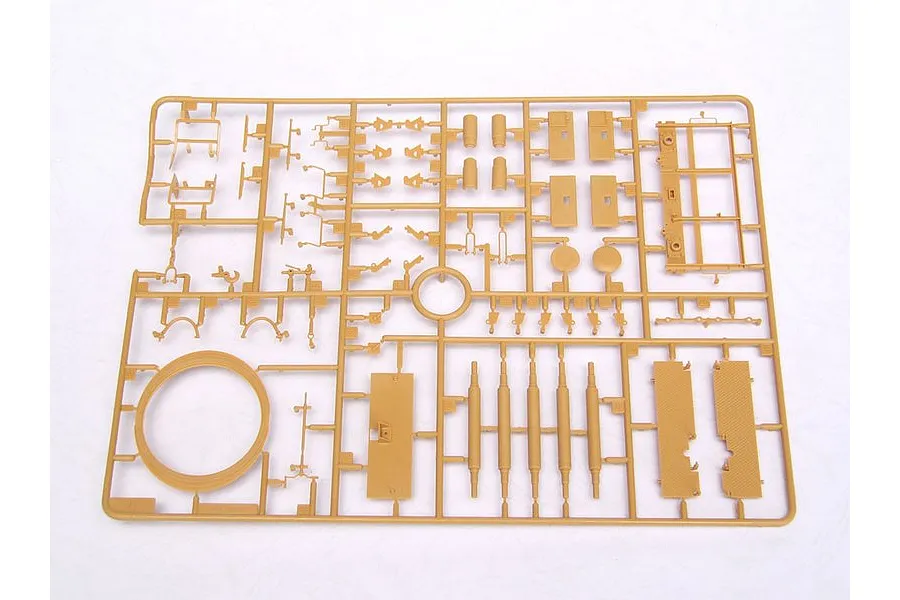 A tan plastic model kit sprue containing various small parts for a military vehicle model, set against a plain white background.