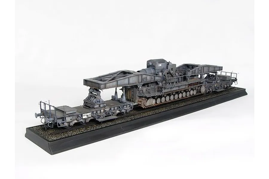 A 1/35 scale model of the German Morser Karl self-propelled mortar mounted on a railway transport carrier, displayed on a black base.