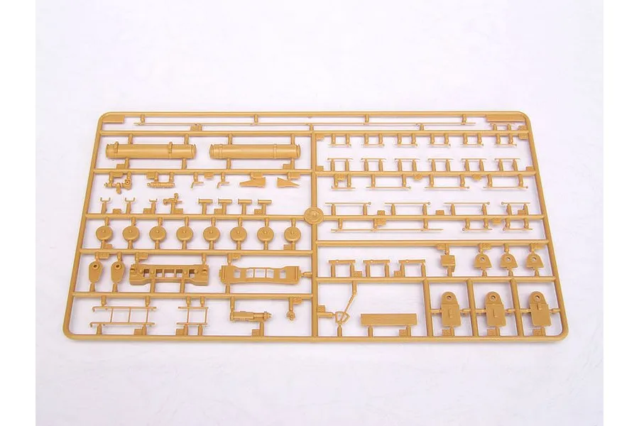 A tan plastic sprue containing various unpainted model kit parts for a military vehicle, laid flat on a white background.
