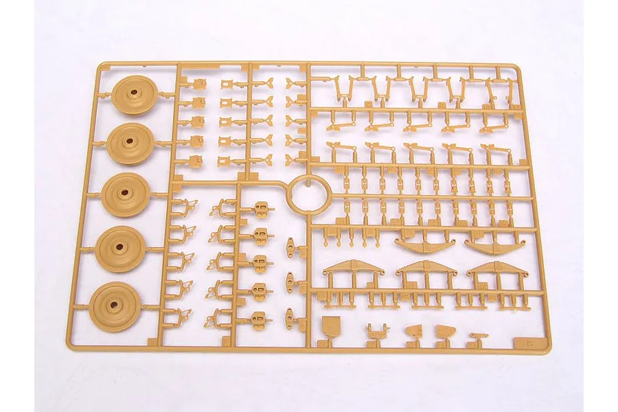 A tan plastic sprue from a Trumpeter 1/35 scale model kit containing various small parts, including wheels and suspension components.