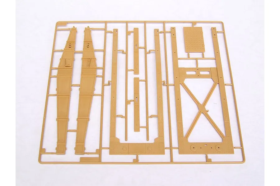 A tan plastic model kit sprue containing various structural parts for a military vehicle model, set against a plain white background.