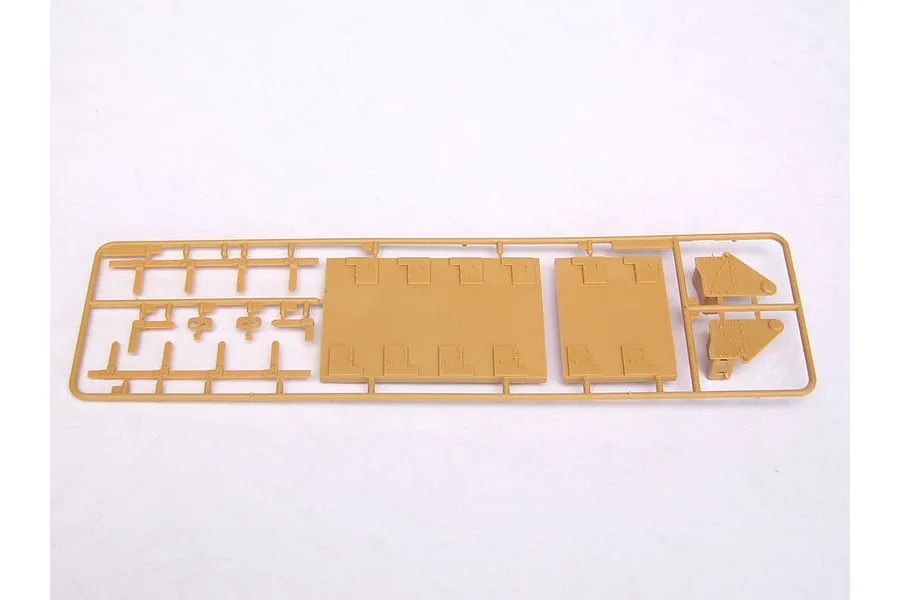 A tan plastic model kit sprue containing flat panels and small mechanical parts for a 1/35 scale military vehicle model.