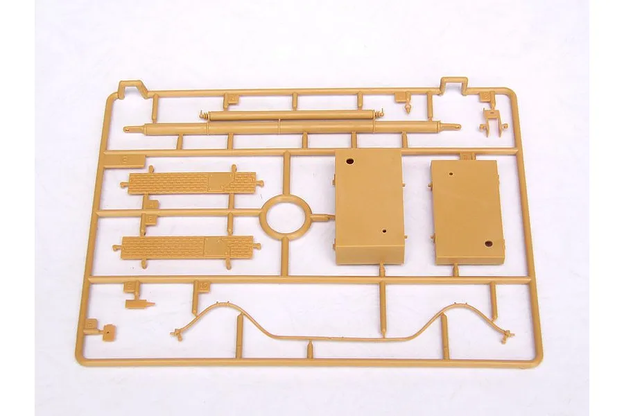 A tan plastic model kit sprue containing various parts for a military vehicle model, set against a plain white background.
