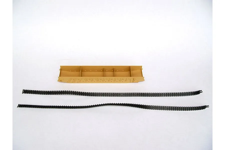 A tan plastic tank hull component and two long black rubber tank tracks for a model kit on a white background.