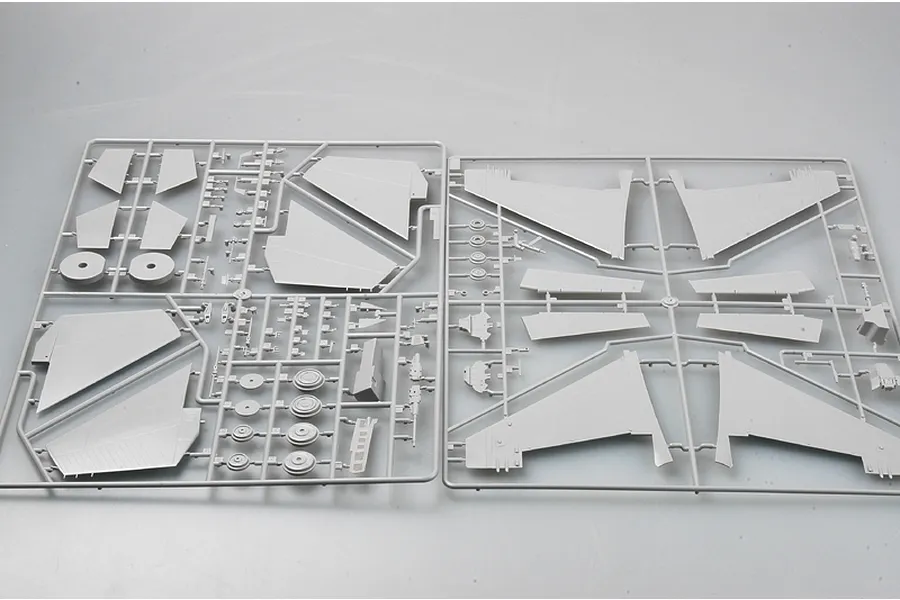Two grey plastic model kit sprues containing aircraft wing and component parts for a 1/32 scale model.