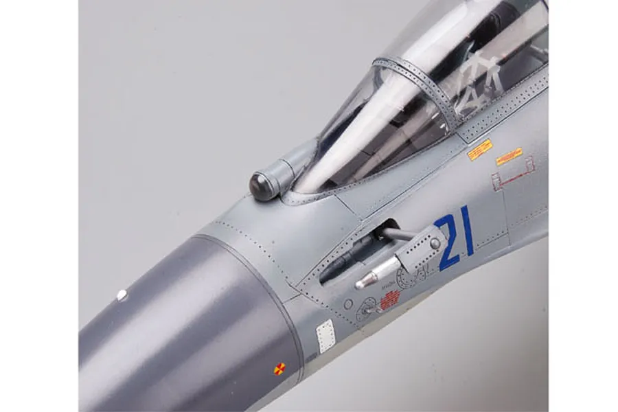 Close-up of the nose and cockpit area of a 1/32 scale Su-30MKK model aircraft, showing detailed grey paint, panel lines, and markings.