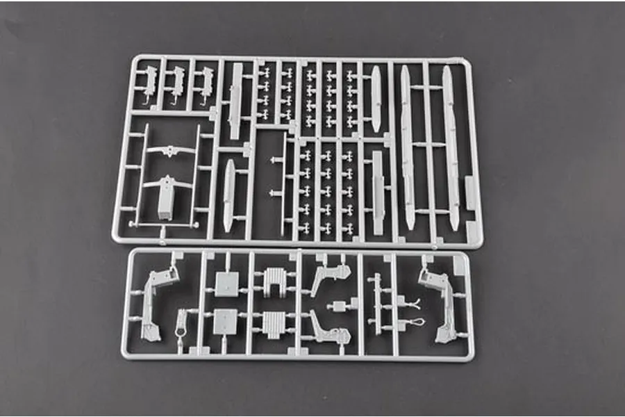 Two grey plastic model kit sprues containing various aircraft parts on a dark grey background.
