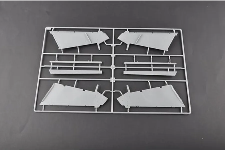 A grey plastic sprue containing four wing or control surface components for a Trumpeter 1/32 scale A-6A Intruder model kit.