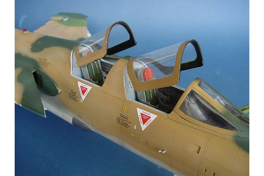 Close-up of a 1/32 scale plastic model F-105G Wild Weasel jet with open tandem cockpits and camouflage paint scheme.