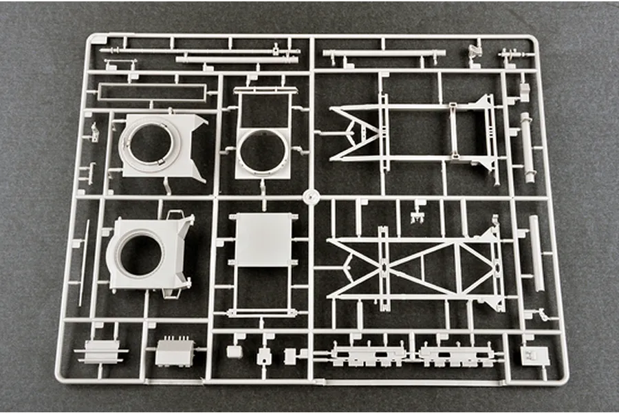 A grey plastic model kit sprue containing various vehicle chassis and structural components for a 1/35 scale military model.