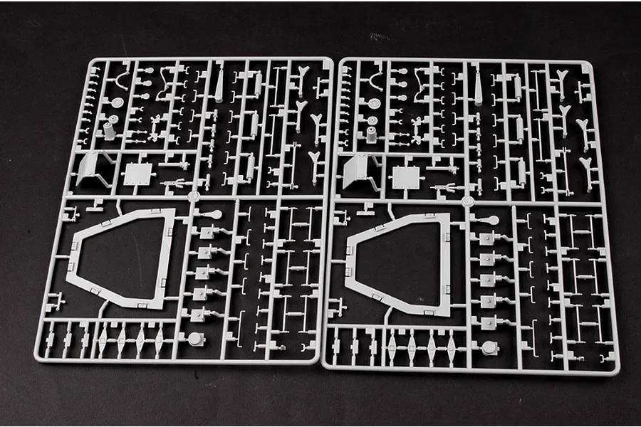 Two identical grey plastic model kit sprues containing various small parts for a 1/35 scale German Panzerlok locomotive model.