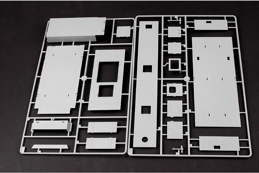 A grey plastic sprue containing various flat panels and structural parts for a 1/35 scale model kit, laid out on a dark background.