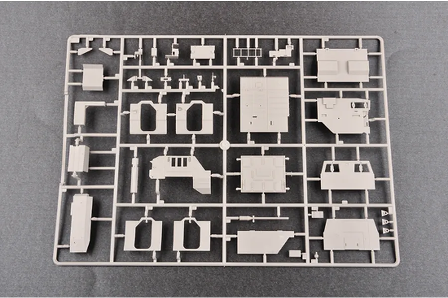 A grey plastic model kit sprue containing various vehicle body panels and components for a 1/35 scale military model.