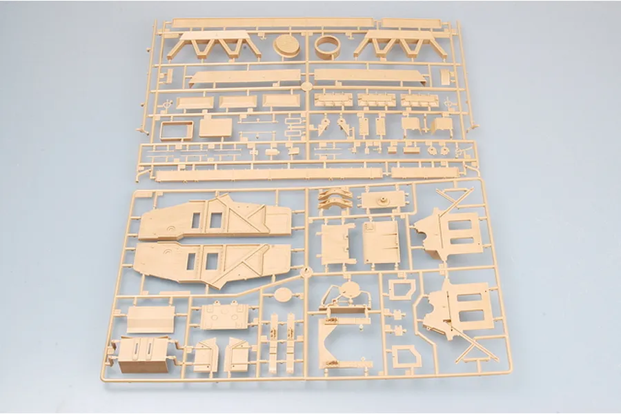 Two tan plastic model kit sprues containing various vehicle parts for a 1/35 scale military model.