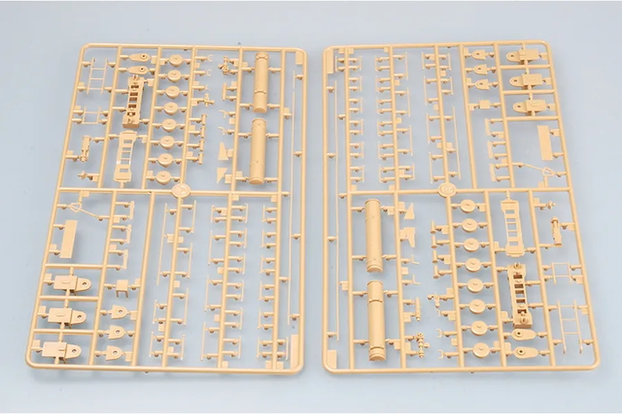 Two tan plastic model kit sprues containing various small parts for a 1/35 scale military vehicle model.