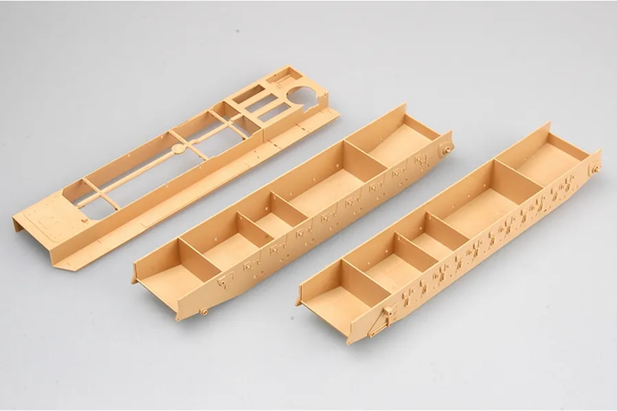 Three tan plastic model tank hull components from a Trumpeter 1/35 scale model kit on a white background.
