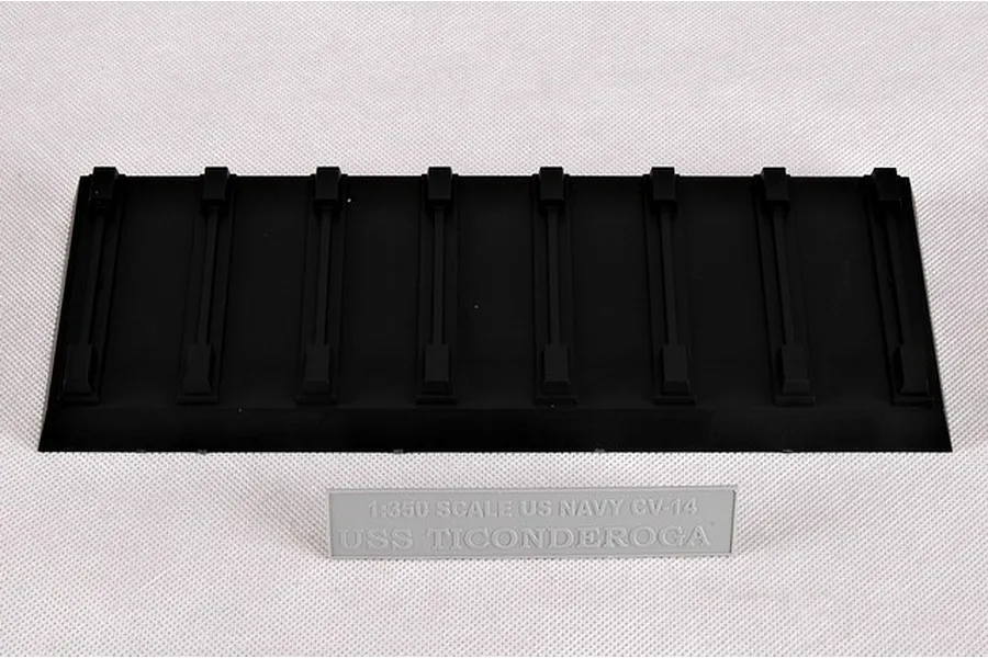 A black plastic display base for a 1/350 scale model ship and a grey nameplate reading 1:350 SCALE US NAVY CV-14 USS TICONDEROGA.
