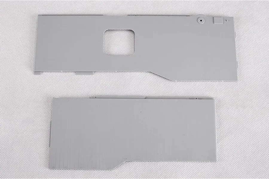 Two grey plastic model kit parts for a 1/350 scale ship model, likely deck sections, laid flat on a white textured surface.