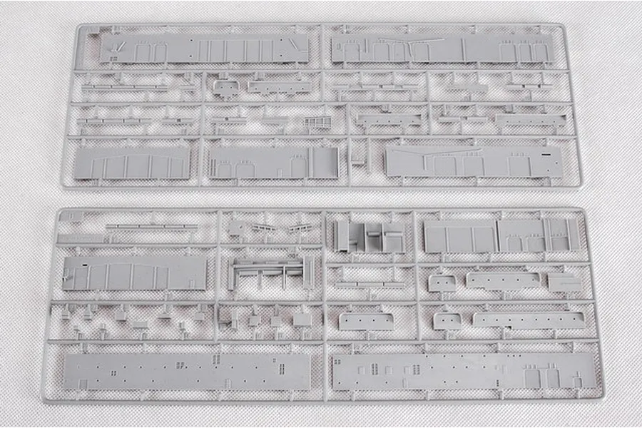 Two grey plastic model kit sprues containing various ship hull and superstructure parts for a 1/350 scale model.