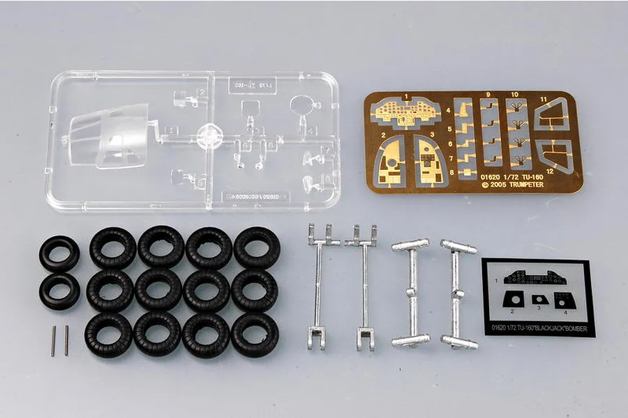 Trumpeter 1/72 TU-160 Blackjack model kit components including clear plastic canopy sprue, photo-etched metal parts, rubber tires, and decal sheet.