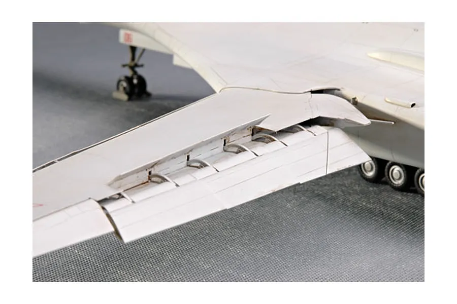 Close-up of a scale model TU-160 Blackjack bomber wing showing detailed flap mechanisms and landing gear.