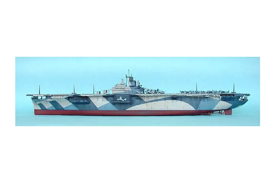 A side-profile view of a 1/350 scale plastic model of the USS Yorktown CV-10 aircraft carrier, featuring a blue and grey camouflage pattern.