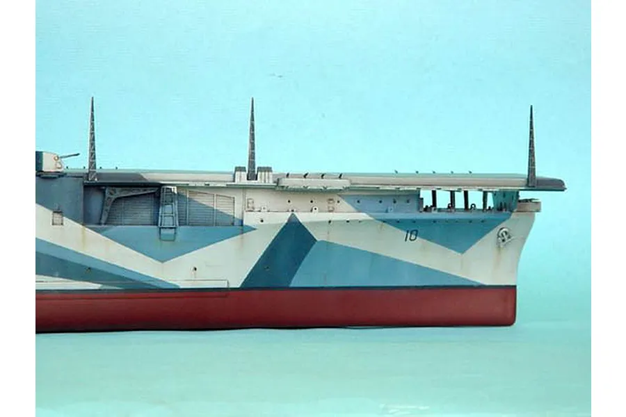 Side view of a 1/350 scale model of the USS Yorktown CV-10 aircraft carrier showing its blue and white camouflage hull and flight deck.