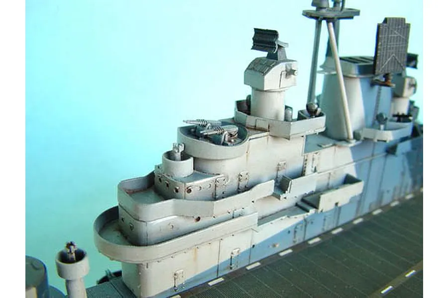 Close-up of the island structure on a 1/350 scale model of the USS Yorktown aircraft carrier, showing detailed radar, gun turrets, and camouflage paint.