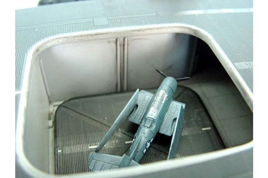 A 1/350 scale model aircraft on the elevator deck of the Trumpeter USS Yorktown aircraft carrier model kit.