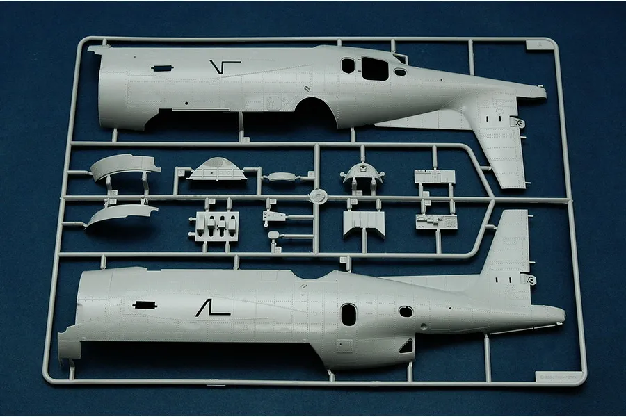 A grey plastic model kit sprue containing fuselage halves and interior components for a 1/32 scale TBM-3 Avenger bomber model.