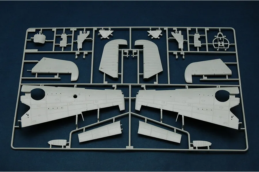 A grey plastic model kit sprue containing various aircraft wing and fuselage parts for a 1/32 scale TBM-3 Avenger model.