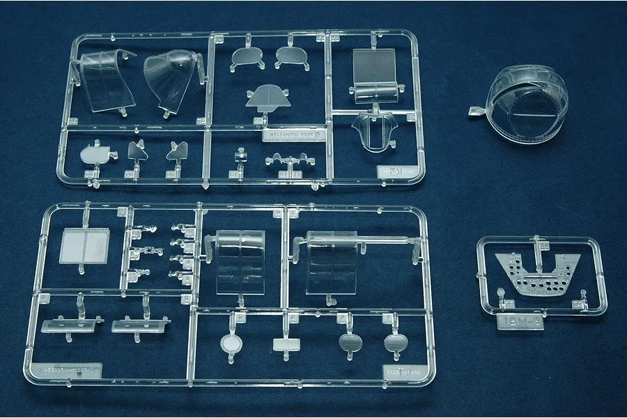 Clear plastic model kit sprues containing aircraft canopy parts and cockpit details for a 1/32 scale TBM-3 Avenger model.