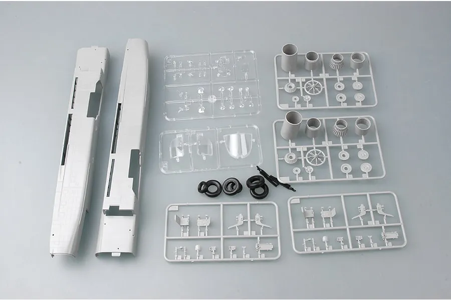 Unassembled plastic model kit parts for a 1/48 scale Su-24M Fencer-D, including grey fuselage halves, sprue frames, clear parts, and rubber tires.
