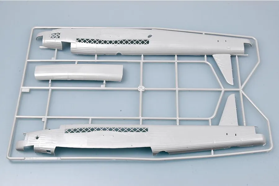 A grey plastic model aircraft sprue containing two fuselage halves and a fuselage panel for a 1/48 scale Wellington bomber model kit.
