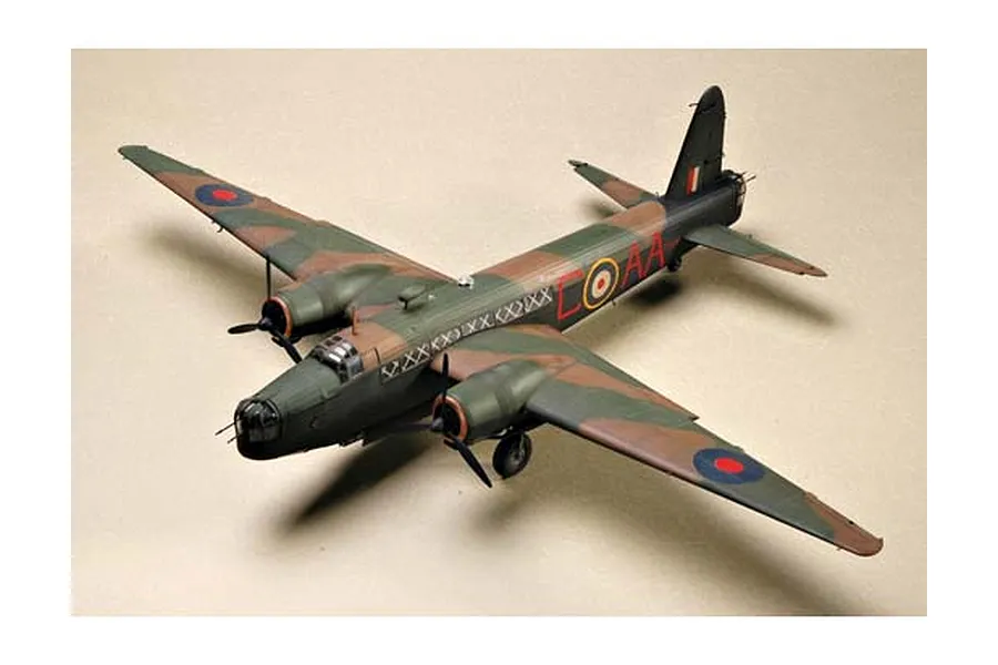 A completed 1/48 scale plastic model of a British Wellington Mk. IC bomber, painted in a green and brown camouflage scheme with RAF markings.
