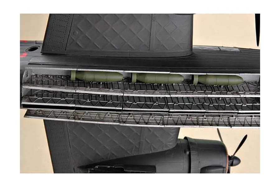Close-up of the open bomb bay on a 1/48 scale model of a Vickers Wellington bomber, showing green bombs and internal structural details.